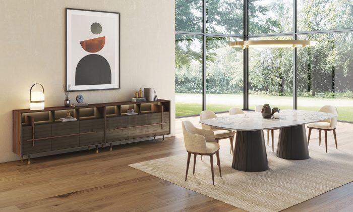 Photo d'ambiance présentant une table de repas ovale fixe. Avec deux pieds en forme de cône avec une finitions noir mat avec un plateau céramique marbré en blanc brillant.